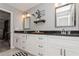 Bathroom featuring double vanity, black granite counters, and decor at 1184 Metropolitan Sw Pkwy, Atlanta, GA 30310