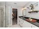 Bathroom featuring double vanity, black granite counters, and marble shower at 1184 Metropolitan Sw Pkwy, Atlanta, GA 30310