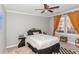 Bedroom with gray walls, ceiling fan, natural light from the windows and unique decor elements at 1184 Metropolitan Sw Pkwy, Atlanta, GA 30310