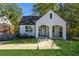 Charming white brick home with an arched covered front porch and well maintained lawn at 1184 Metropolitan Sw Pkwy, Atlanta, GA 30310