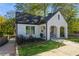 Charming white brick home featuring a covered arched porch and well-manicured lawn at 1184 Metropolitan Sw Pkwy, Atlanta, GA 30310