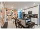 Modern kitchen with white cabinets, black countertops, a central island, and stylish accent wall at 1184 Metropolitan Sw Pkwy, Atlanta, GA 30310