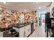 Modern kitchen featuring a granite island, white cabinetry, stainless steel appliances, and decorative wall at 1184 Metropolitan Sw Pkwy, Atlanta, GA 30310