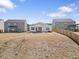 Home's backyard showcasing dry grass, a patio, and neighboring houses at 2030 Vidalia Court, Dacula, GA 30019