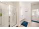 Bright bathroom featuring a tiled floor, glass shower, and soaking tub, offering a spa-like experience at 2030 Vidalia Court, Dacula, GA 30019
