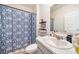 Bathroom featuring a vanity with a marble countertop and a patterned shower curtain at 2030 Vidalia Court, Dacula, GA 30019