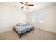 Bright bedroom with neutral carpet, ceiling fan, and a large window offering ample natural light at 2030 Vidalia Court, Dacula, GA 30019