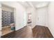 View of foyer featuring hardwood flooring and access to a bathroom and bedroom at 2030 Vidalia Court, Dacula, GA 30019