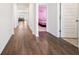 Hallway boasts elegant wood flooring and leads to several rooms including a bright bedroom at 2030 Vidalia Court, Dacula, GA 30019