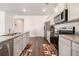 Modern kitchen features granite countertops, stainless appliances, and dark wood flooring at 2030 Vidalia Court, Dacula, GA 30019