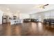 Spacious living room featuring a kitchen island, stainless appliances, hardwood floors, and a dining area at 2030 Vidalia Court, Dacula, GA 30019