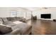 Comfortable living room with a large sectional sofa, TV, and plenty of natural light at 2030 Vidalia Court, Dacula, GA 30019