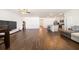 Expansive living room with hardwood floors, kitchen island, and modern lighting, creating a bright and inviting space at 2030 Vidalia Ct, Dacula, GA 30019