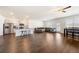 Spacious living room showcasing hardwood floors, a kitchen island with bar stools, and a cozy seating area near the dining space at 2030 Vidalia Ct, Dacula, GA 30019