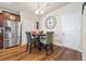 Dining area featuring hardwood floors, a table with chairs, and a modern light fixture at 6119 Hickory Lane Dr, Union City, GA 30291