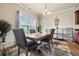 Dining room features a modern table, decorative rug, and bright natural light from a large window at 6119 Hickory Lane Dr, Union City, GA 30291