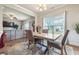 Well-lit dining area connected to the living room with neutral walls and view of backyard at 6119 Hickory Lane Dr, Union City, GA 30291