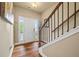 Inviting foyer with hardwood floors, a staircase, and a bright white front door with sidelights at 6119 Hickory Lane Dr, Union City, GA 30291