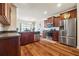 Modern kitchen with stainless steel appliances, dark wood cabinets, and hardwood floors at 6119 Hickory Lane Dr, Union City, GA 30291
