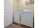 Convenient laundry room with washer, dryer, and wire shelf storage at 6119 Hickory Lane Dr, Union City, GA 30291