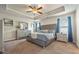 Spacious main bedroom featuring a tray ceiling, plush carpet, and a comfortable king bed at 6119 Hickory Lane Dr, Union City, GA 30291
