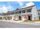 New townhomes featuring craftsman-style architecture, private garages, and well-manicured lawns under a partially cloudy sky at 2520 Coventry Street, Atlanta, GA 30331