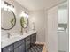 Bright bathroom with double vanity, modern fixtures, and a convenient closet with a washer and dryer at 3167 Northbrook Dr, Atlanta, GA 30341