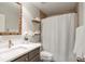 Bathroom with decorative mirror, white vanity, floating shelves and a white shower curtain at 3167 Northbrook Dr, Atlanta, GA 30341
