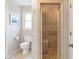 Bright bathroom featuring a shower with tile surround, handrails, and a tiled floor at 3167 Northbrook Dr, Atlanta, GA 30341