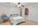 Bright bedroom featuring a ceiling fan, a comfortable bed with cozy cushions, and an accent chair near the window at 3167 Northbrook Dr, Atlanta, GA 30341