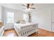 Bedroom with hardwood floors, ceiling fan, two windows, and a queen bed with white linens at 3167 Northbrook Dr, Atlanta, GA 30341
