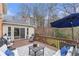 Inviting outdoor deck featuring comfortable seating with a blue umbrella and wooded views at 3167 Northbrook Dr, Atlanta, GA 30341