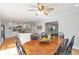 View of dining area connecting to kitchen with ceiling fan, hardwood floors, and natural light at 3167 Northbrook Dr, Atlanta, GA 30341