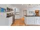 Bright kitchen with white cabinets, stainless steel appliances, hardwood floors, and black countertops at 3167 Northbrook Dr, Atlanta, GA 30341