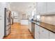 Modern kitchen featuring white cabinets, dark granite countertops, stainless steel appliances, and hardwood floors at 3167 Northbrook Dr, Atlanta, GA 30341