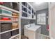 Organized laundry room with built-in shelving and a modern washer and dryer at 3167 Northbrook Dr, Atlanta, GA 30341