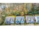 Aerial view showcasing homes, trees, and neighborhood landscape during autumn at 4273 Creekrun Cir, Buford, GA 30519