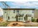 Exterior view of backyard with fire pit, patio, and well-maintained landscaping at 4273 Creekrun Cir, Buford, GA 30519