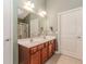 Bathroom featuring double sinks, cherry cabinets, and a large mirror at 4273 Creekrun Cir, Buford, GA 30519