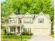 Charming two-story home featuring light green siding, green shutters, and a well-manicured lawn at 4273 Creekrun Cir, Buford, GA 30519
