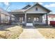 Charming home featuring a covered front porch with sturdy columns and fresh landscaping at 1050 Lawton Sw Ave, Atlanta, GA 30310