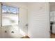Small laundry room features white walls and wood floor at 1050 Lawton Sw Ave, Atlanta, GA 30310