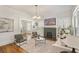 This bright living room features hardwood floors, neutral paint, and a black brick fireplace at 1050 Lawton Sw Ave, Atlanta, GA 30310