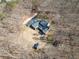Overhead view of a unique home with a dark roof and additional outbuilding on a wooded property at 170 River Cove Rdg, Social Circle, GA 30025