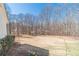 Large backyard with a clear blue sky and sparse trees at 170 River Cove Rdg, Social Circle, GA 30025