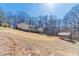 Sprawling backyard with mature trees and a covered outdoor area, perfect for entertaining and enjoying nature at 170 River Cove Rdg, Social Circle, GA 30025