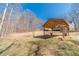 Covered outdoor structure in a spacious backyard, ideal for relaxation and enjoying the natural surroundings at 170 River Cove Rdg, Social Circle, GA 30025