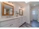 Bright bathroom with dual vanity sinks, wood-framed mirrors, and stylish tile flooring at 170 River Cove Rdg, Social Circle, GA 30025