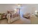 Cozy bedroom with a ceiling fan, carpet, and an armchair at 170 River Cove Rdg, Social Circle, GA 30025