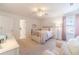 Well-lit bedroom features carpet, a ceiling fan, and light-colored walls at 170 River Cove Rdg, Social Circle, GA 30025